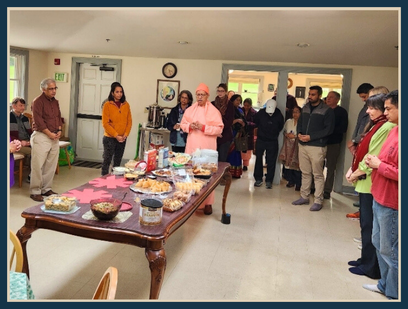 Devotees pray with Swami Satyamayananda before eating